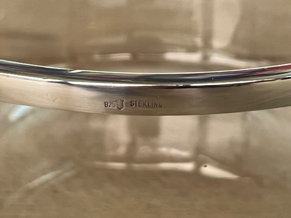A cylindrical clear glass bowl featuring a smooth polished sterling silver rim around the top edge. View IV
