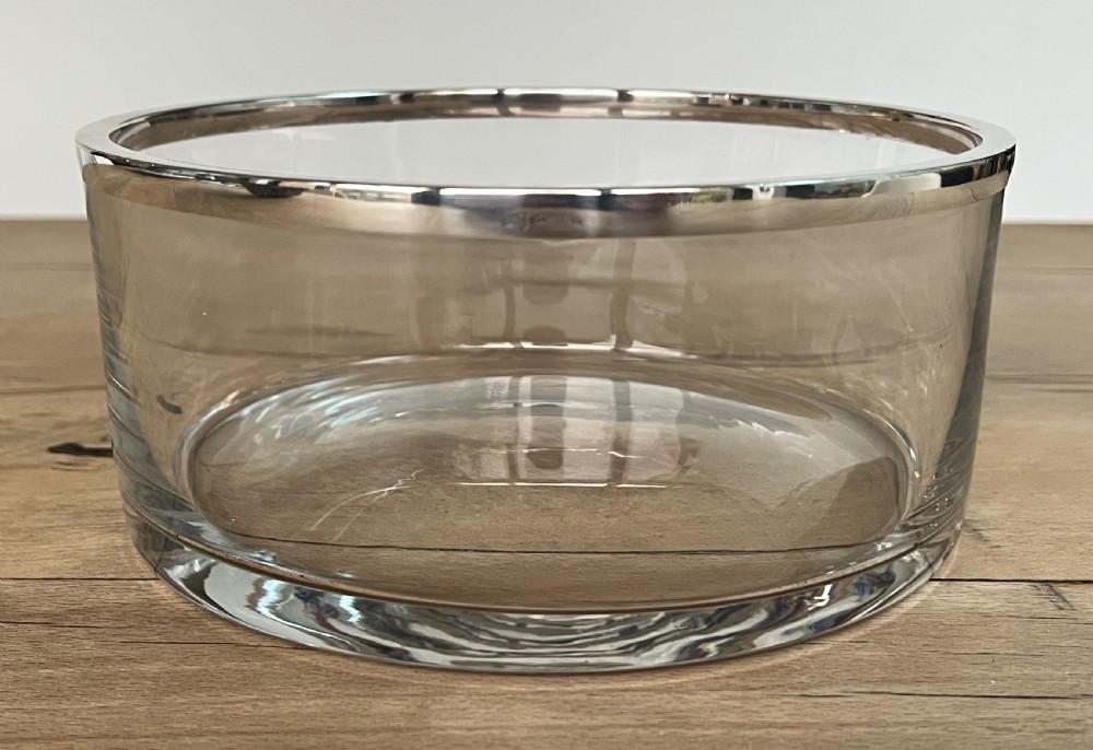 A cylindrical clear glass bowl featuring a smooth polished sterling silver rim around the top edge. View V