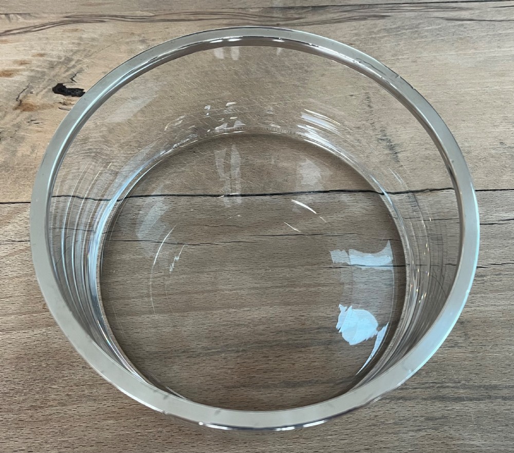 A cylindrical clear glass bowl featuring a smooth polished sterling silver rim around the top edge. View VI