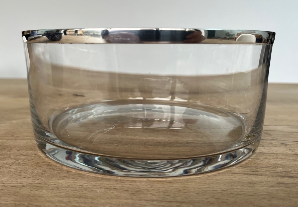 A cylindrical clear glass bowl featuring a smooth polished sterling silver rim around the top edge. View VII