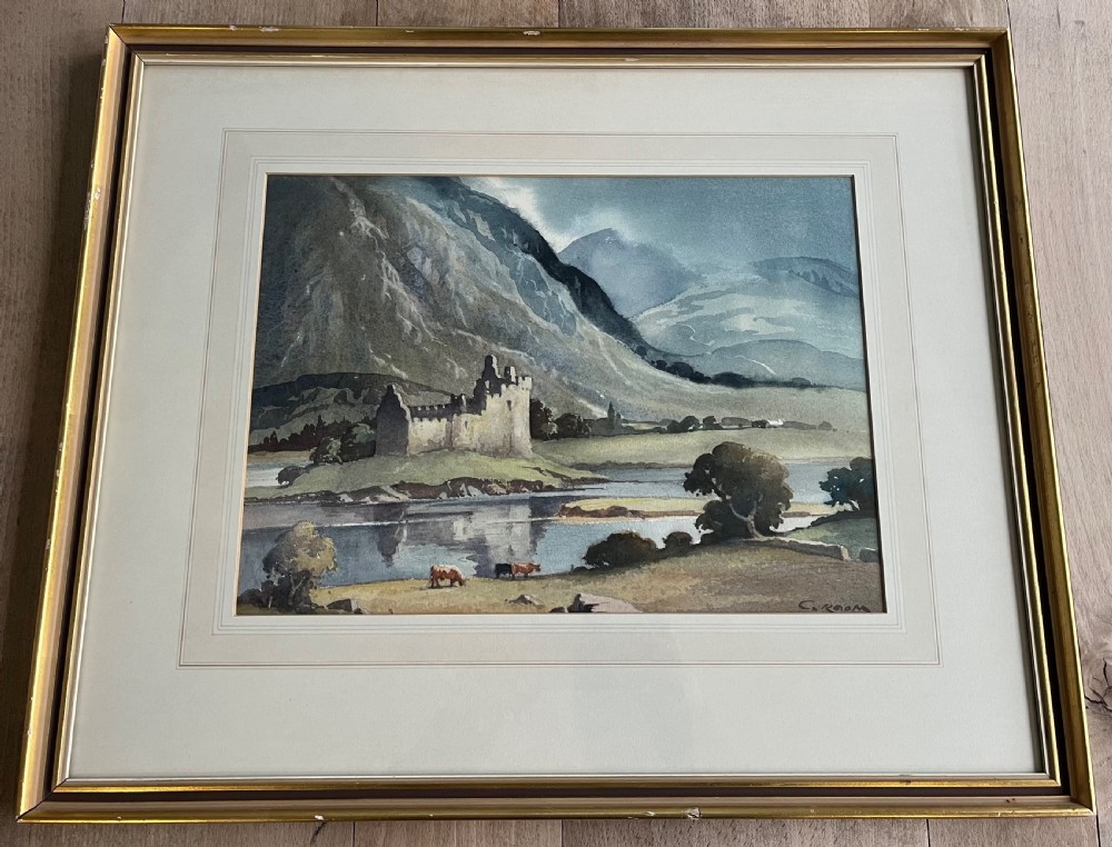 A framed watercolour painting by Emerson H. Groom depicting Kilchurn Castle on the banks of Loch Awe set against a backdrop of mountains.