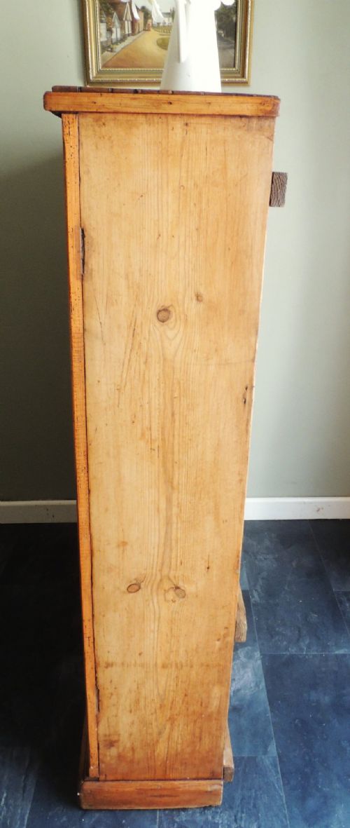 A tall Victorian open-front pine bookcase featuring four spacious shelves and a planked backboard resting on a solid plinth base. View X