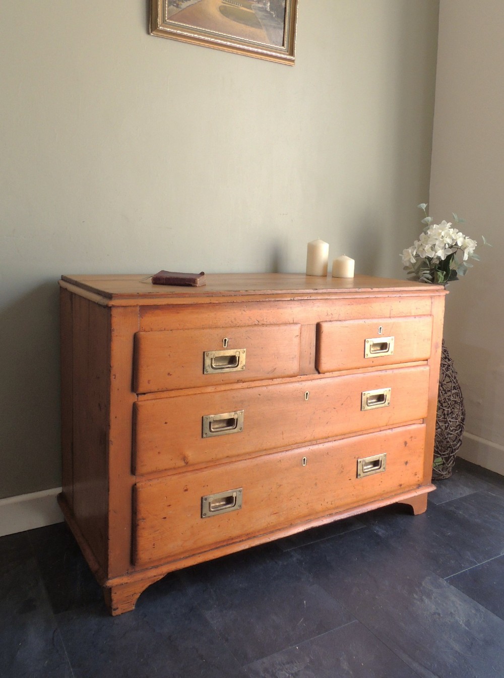 A Victorian solid pine chest of drawers featuring two short drawers over two long drawers fitted with flush brass handles.