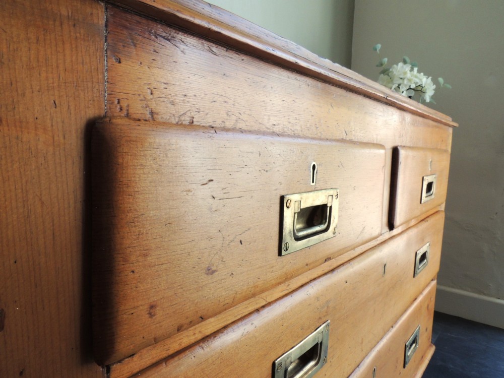 A Victorian solid pine chest of drawers featuring two short drawers over two long drawers fitted with flush brass handles. View III