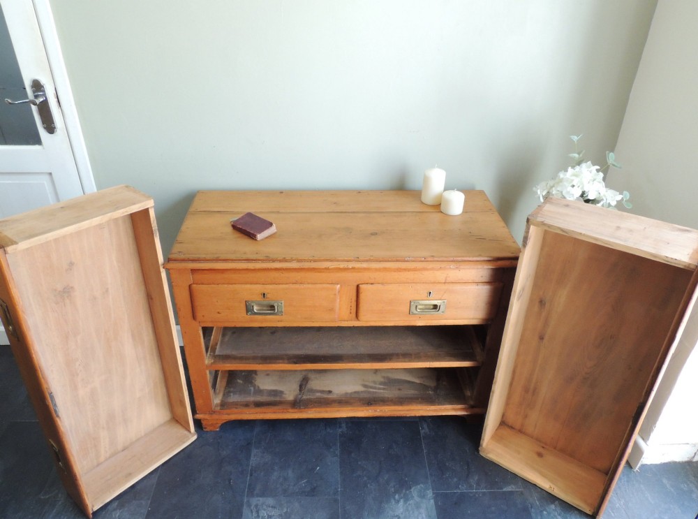 A Victorian solid pine chest of drawers featuring two short drawers over two long drawers fitted with flush brass handles. View VIII