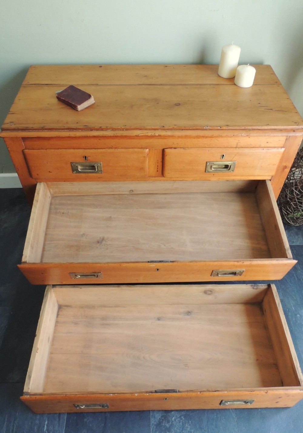 A Victorian solid pine chest of drawers featuring two short drawers over two long drawers fitted with flush brass handles. View X