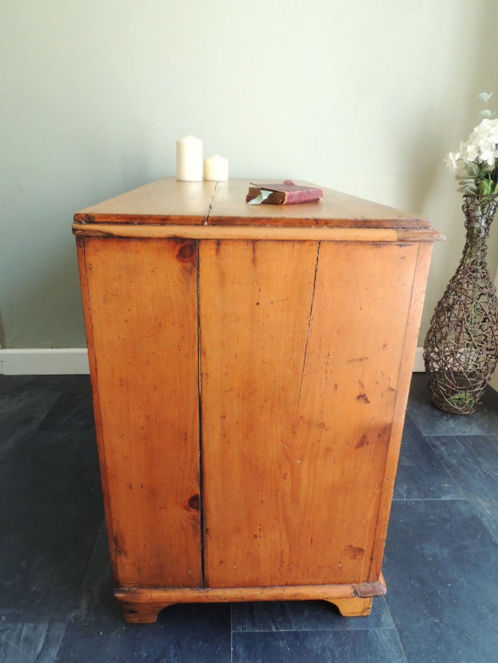A Victorian solid pine chest of drawers featuring two short drawers over two long drawers fitted with flush brass handles. View XII