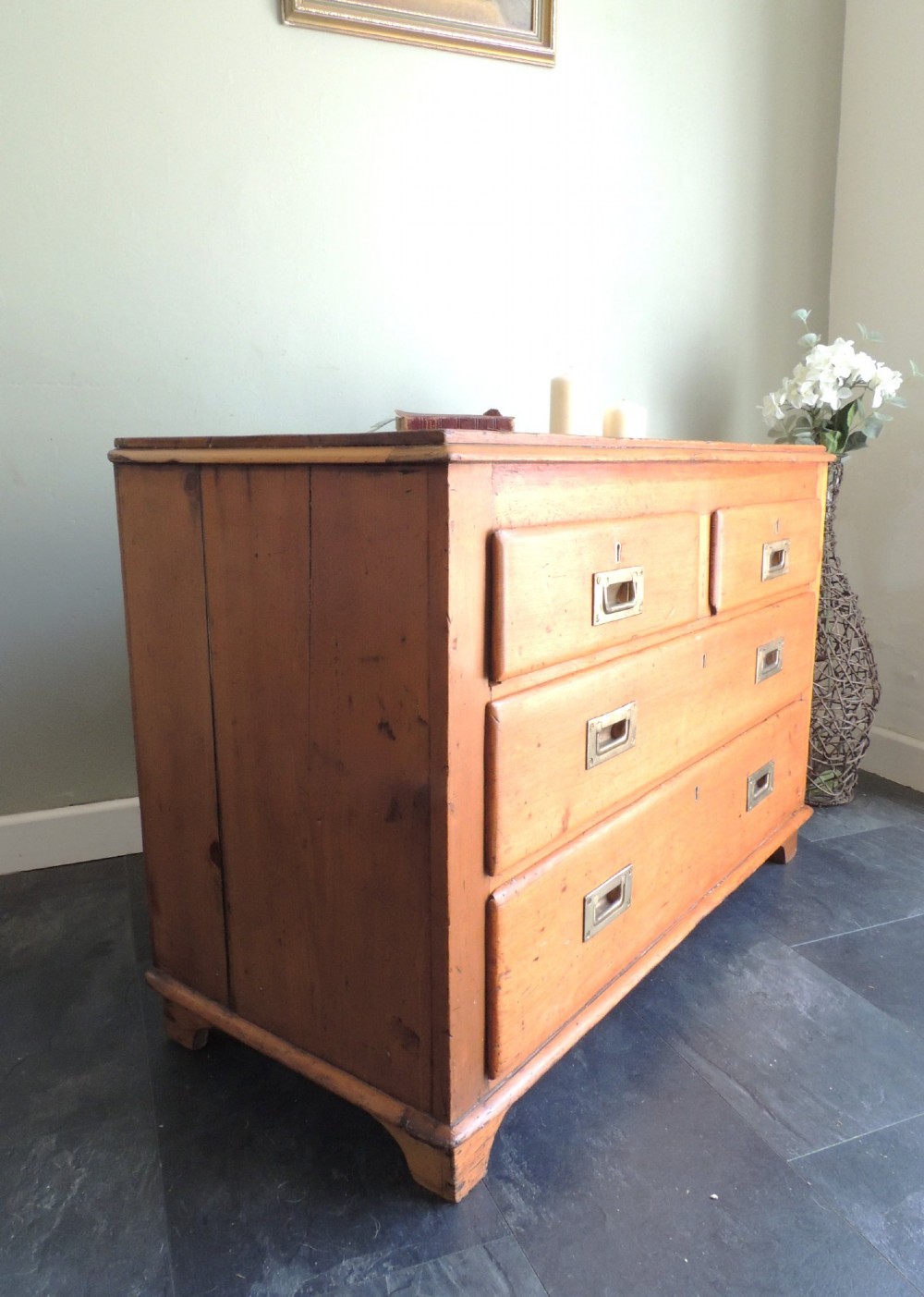 A Victorian solid pine chest of drawers featuring two short drawers over two long drawers fitted with flush brass handles. View XV