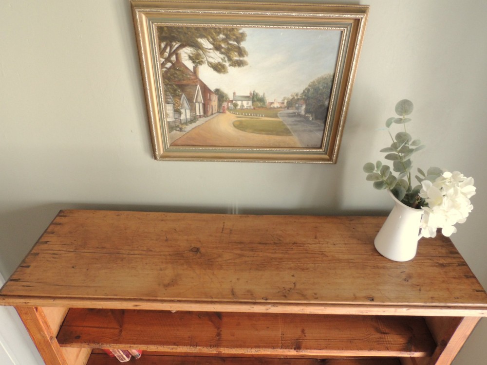 A tall Victorian open-front pine bookcase featuring four spacious shelves and a planked backboard resting on a solid plinth base. View VIII