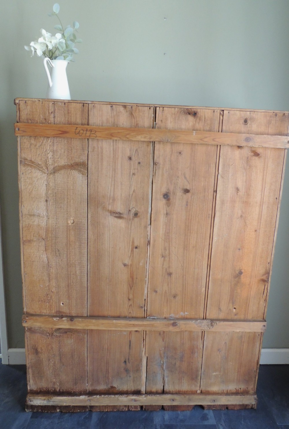 A tall Victorian open-front pine bookcase featuring four spacious shelves and a planked backboard resting on a solid plinth base. View XII