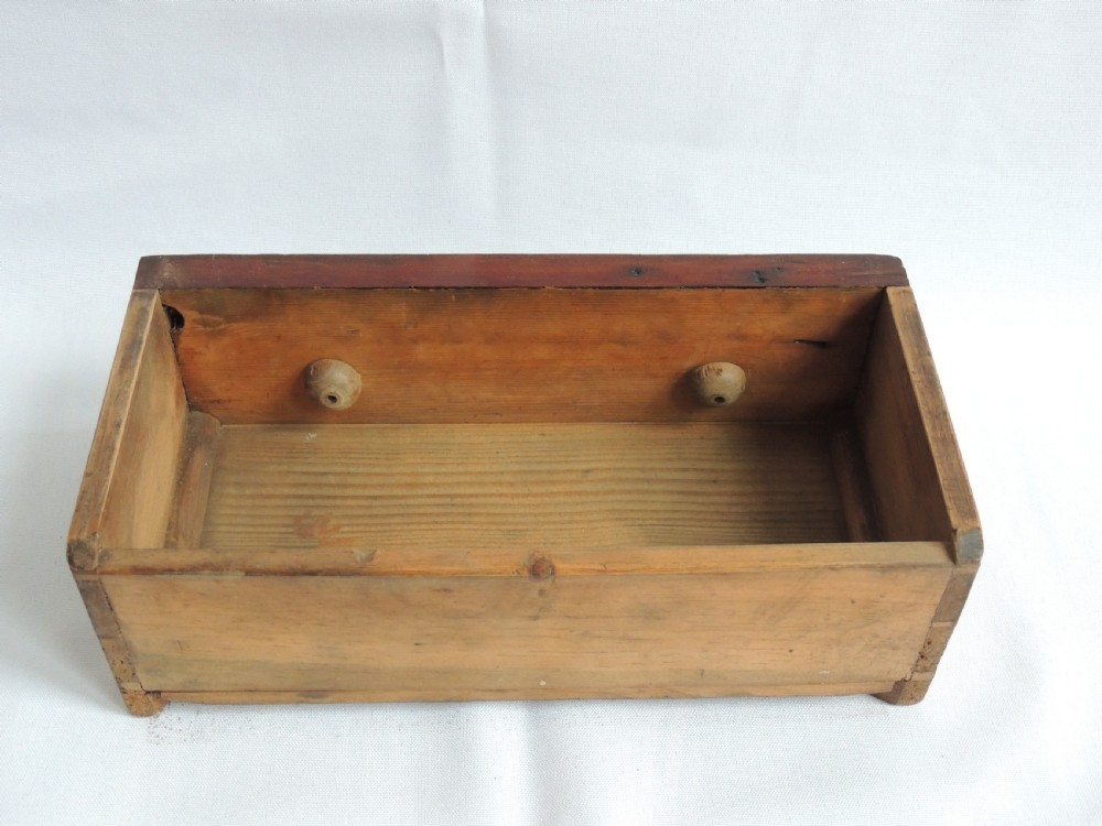A dark stained pine Victorian miniature chest of drawers featuring six drawers with turned wooden knobs and a shaped plinth base. View XVII