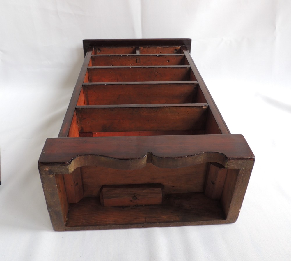 A dark stained pine Victorian miniature chest of drawers featuring six drawers with turned wooden knobs and a shaped plinth base. View XIX