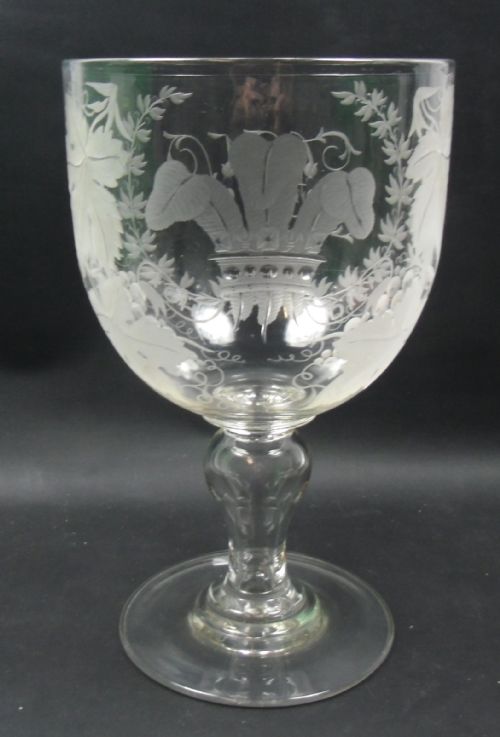 A LARGE CRYSTAL GLASS SERVING RUMMER ENGRAVES WITH THE PRINCE OF WALES FEATHERS SURROUNDED BY FRUITING VINES 'HN' ON REVERSE ENGLISH C1850