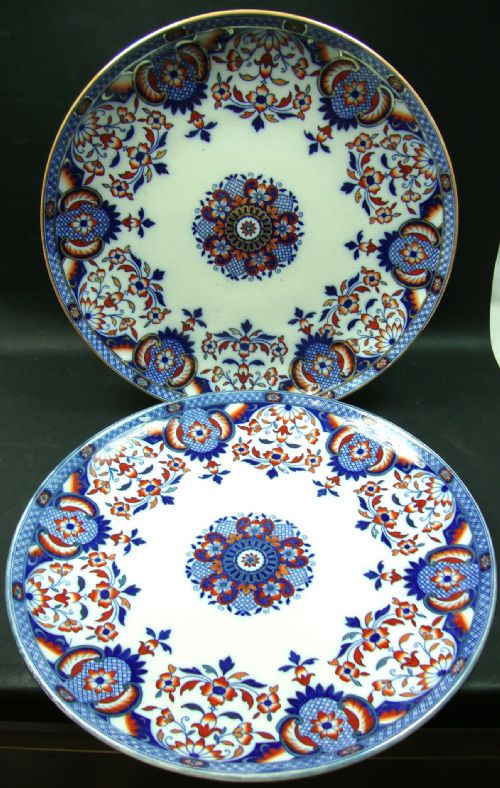 AN UNUSUAL PAIR OF LARGE ROUND CERAMIC CHARGERS WITH IMARI COLOURED DECORATION MINTONS DATE MARK 1881