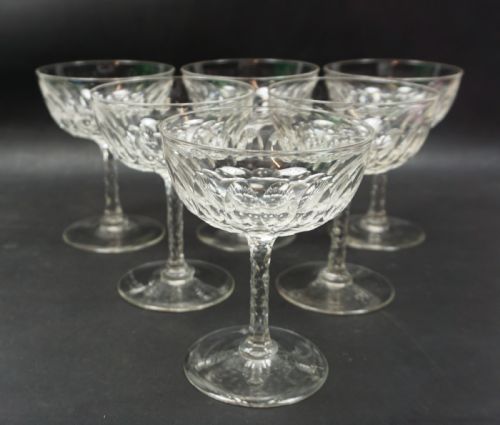A SET OF LARGE CRYSTAL CHAMPAGNE COUPES WITH FACET CUT STEMS ENGLISH C1890