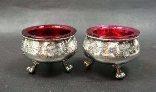 A PAIR OF SILVER PLATED SALT CELLARS WITH CRANBERRY GLASS LINERS ENGLISH C1870