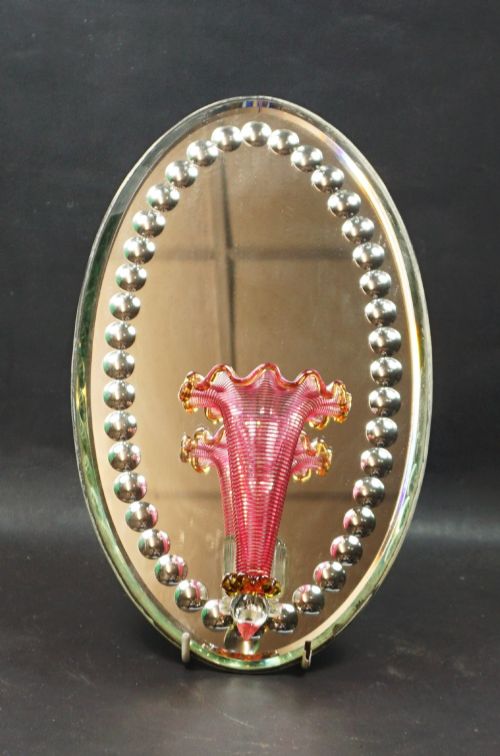 An Oval Hanging Mirror with Cranberry Glass Flower Vase, English C.1880