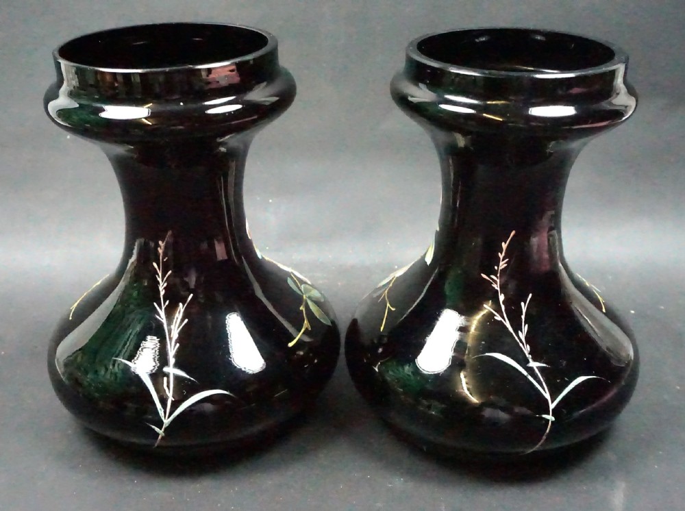 A pair of dark amethyst glass bulb vases decorated with hand-painted white and pink wild rose enamel motifs. View II