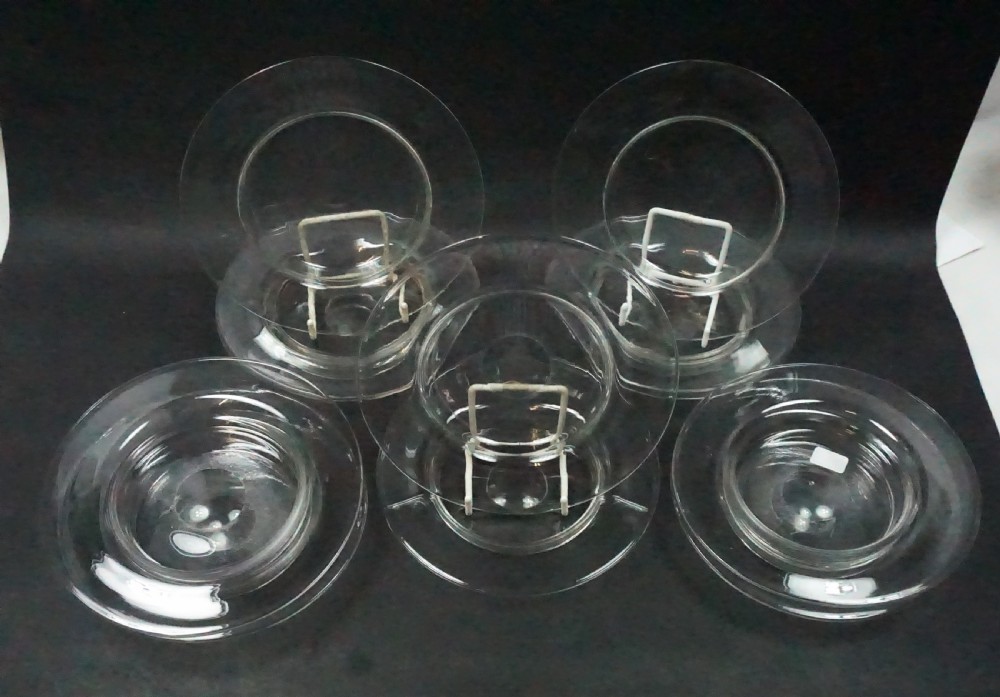 A set of twelve clear free-blown Victorian crystal glass ice plates displayed on stands and stacked. View II