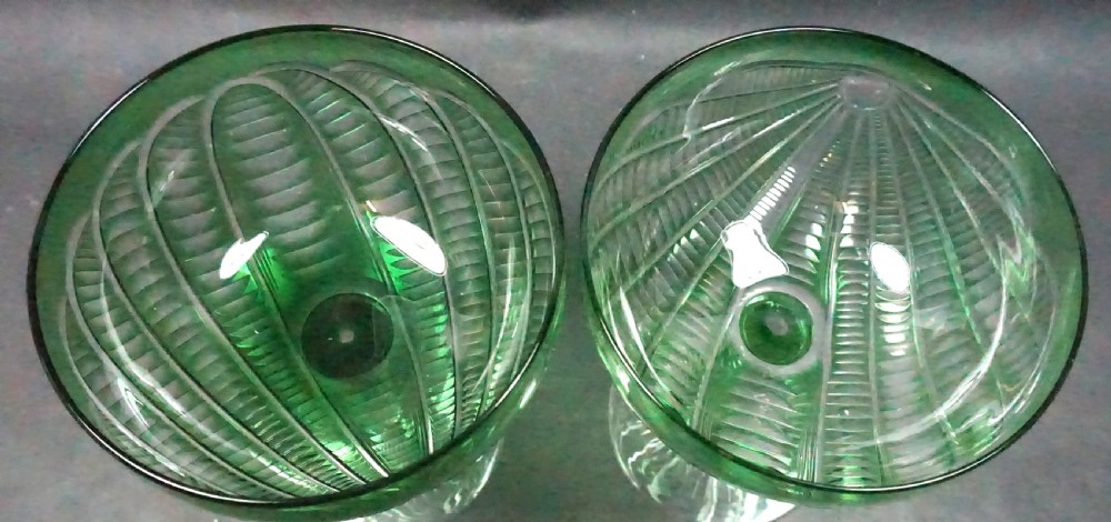 A pair of antique green cut-to-clear crystal champagne coupes featuring faceted stems and starburst cut bases. View II