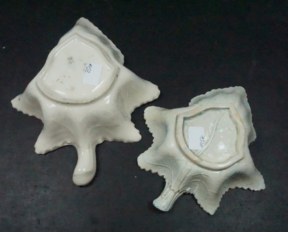 A pair of early nineteenth-century leaf-shaped ceramic pickle dishes featuring blue transfer-printed landscape patterns and molded stem handles. View II