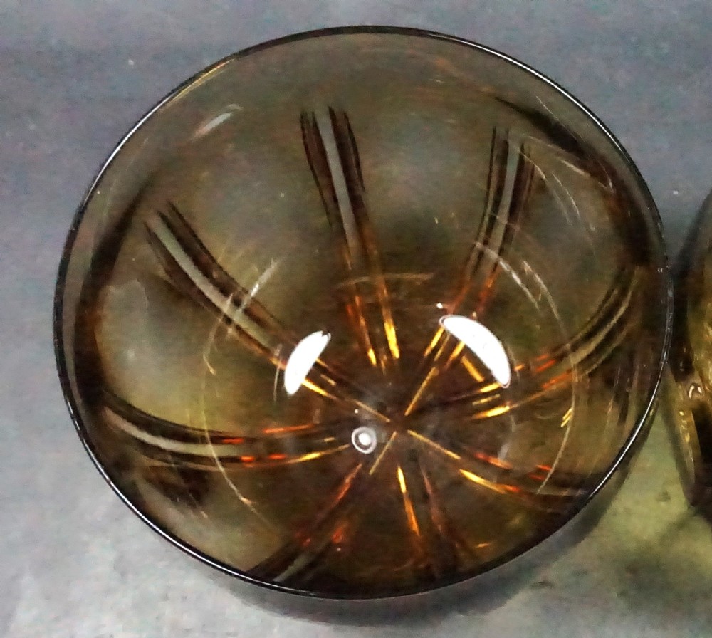 A pair of rounded Georgian amber glass finger bowls featuring vertical cut facets and circular lens cuts around the body. View II