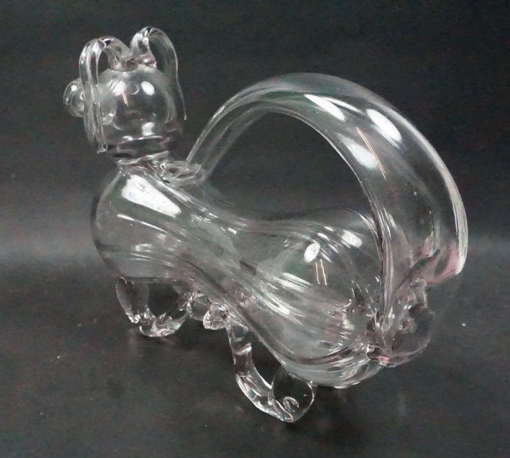 A clear hand-blown glass decanter sculpted in the shape of a dog with an integrated loop handle and snout spout. View II