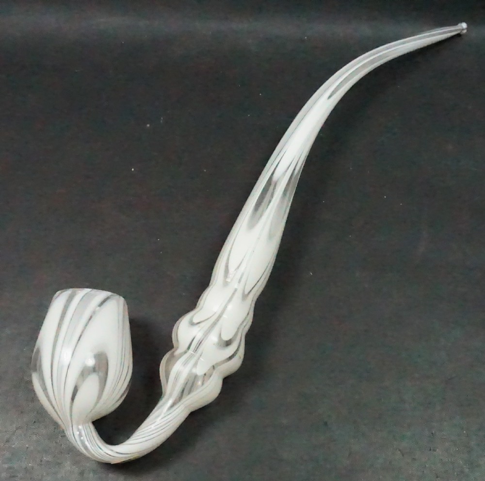An antique Victorian white and clear combed glass pipe featuring a curved stem and bulbous bowl.