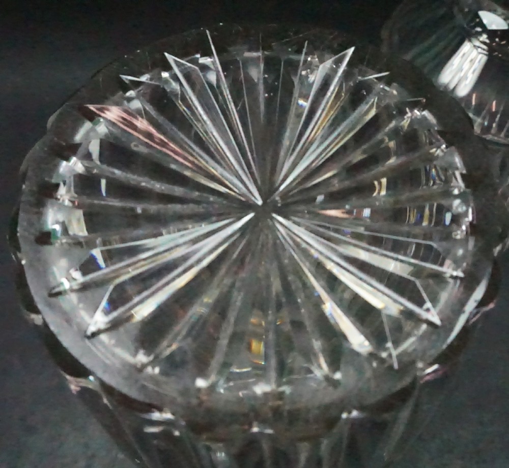 A pair of antique Regency clear cut crystal decanters featuring neck rings, vertical pillar cut bodies, and faceted stoppers. View III