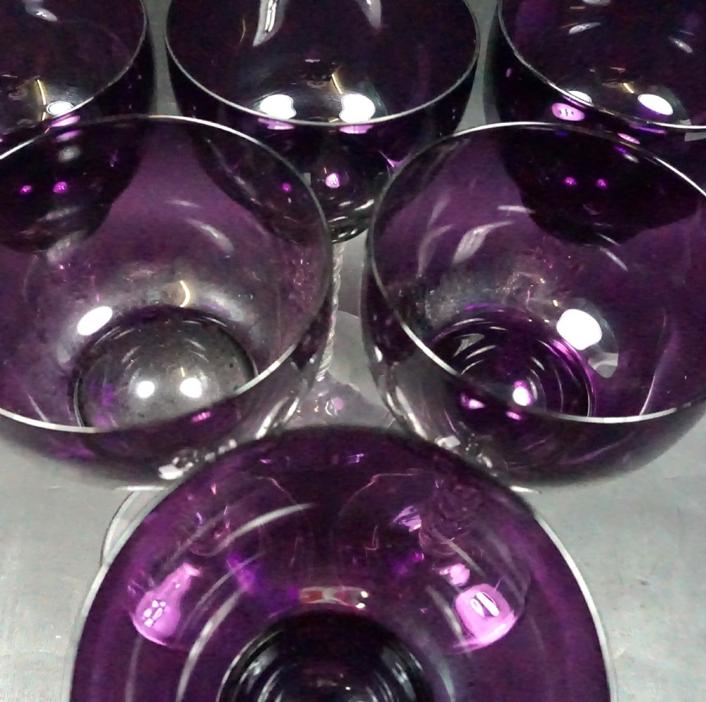 A set of six Victorian wine glasses featuring deep purple amethyst-coloured bowls supported by clear glass bobbin-turned stems. View II
