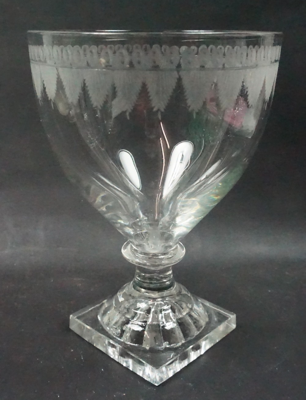 A set of four clear antique crystal glass rummers featuring wheel-engraved bowls and square lemon squeezer moulded bases. View III