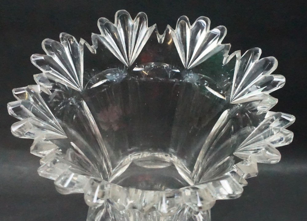 A Regency period clear lead crystal glass celery vase featuring a scalloped fan-cut rim, panel-cut sides, and a circular star-cut base. View II