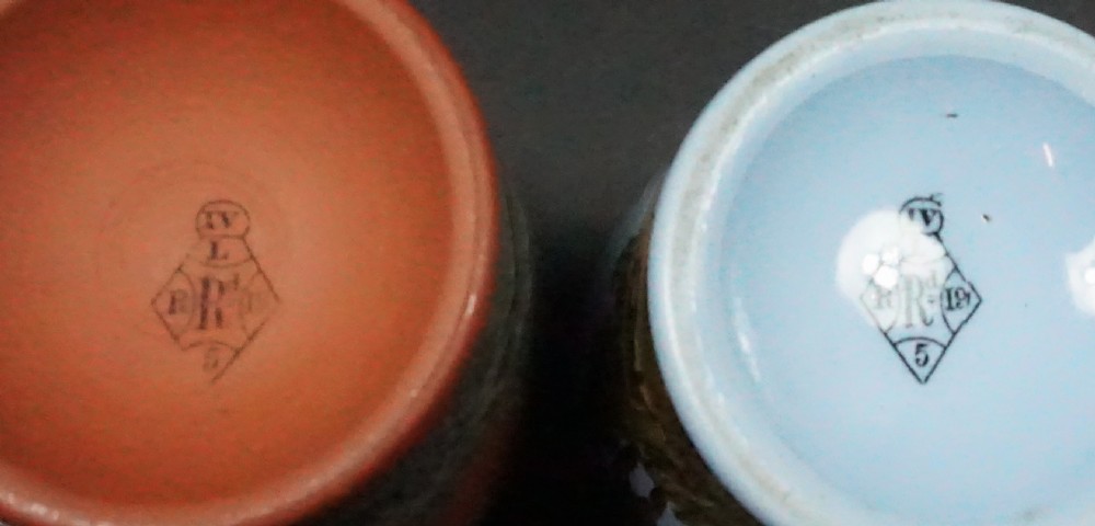 Four small Victorian ceramic paste jars, two in unglazed terracotta and two in light blue glaze, featuring dark transfer-printed equestrian scenes around their body. View II
