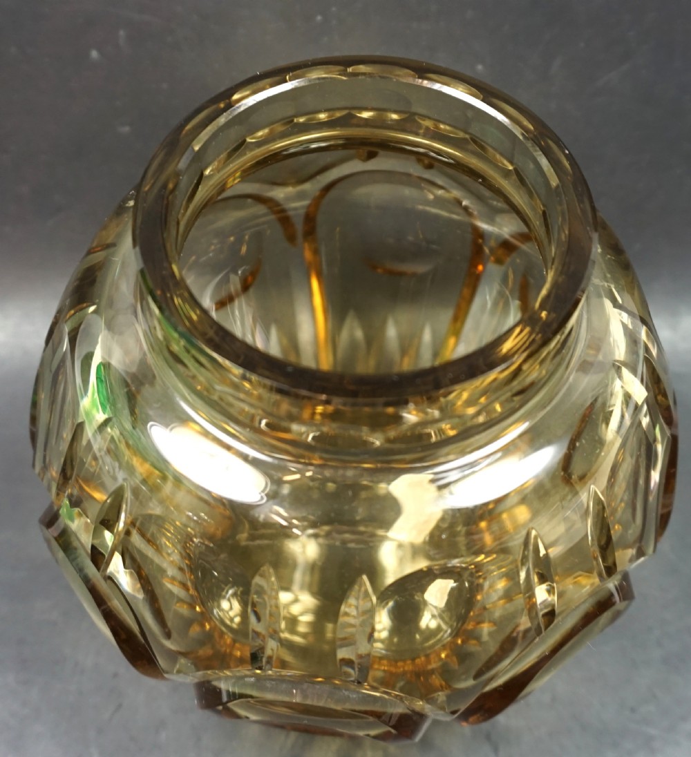 An Art Deco topaz-coloured cut glass vase featuring deep geometric oval facets and a notched rim. View II