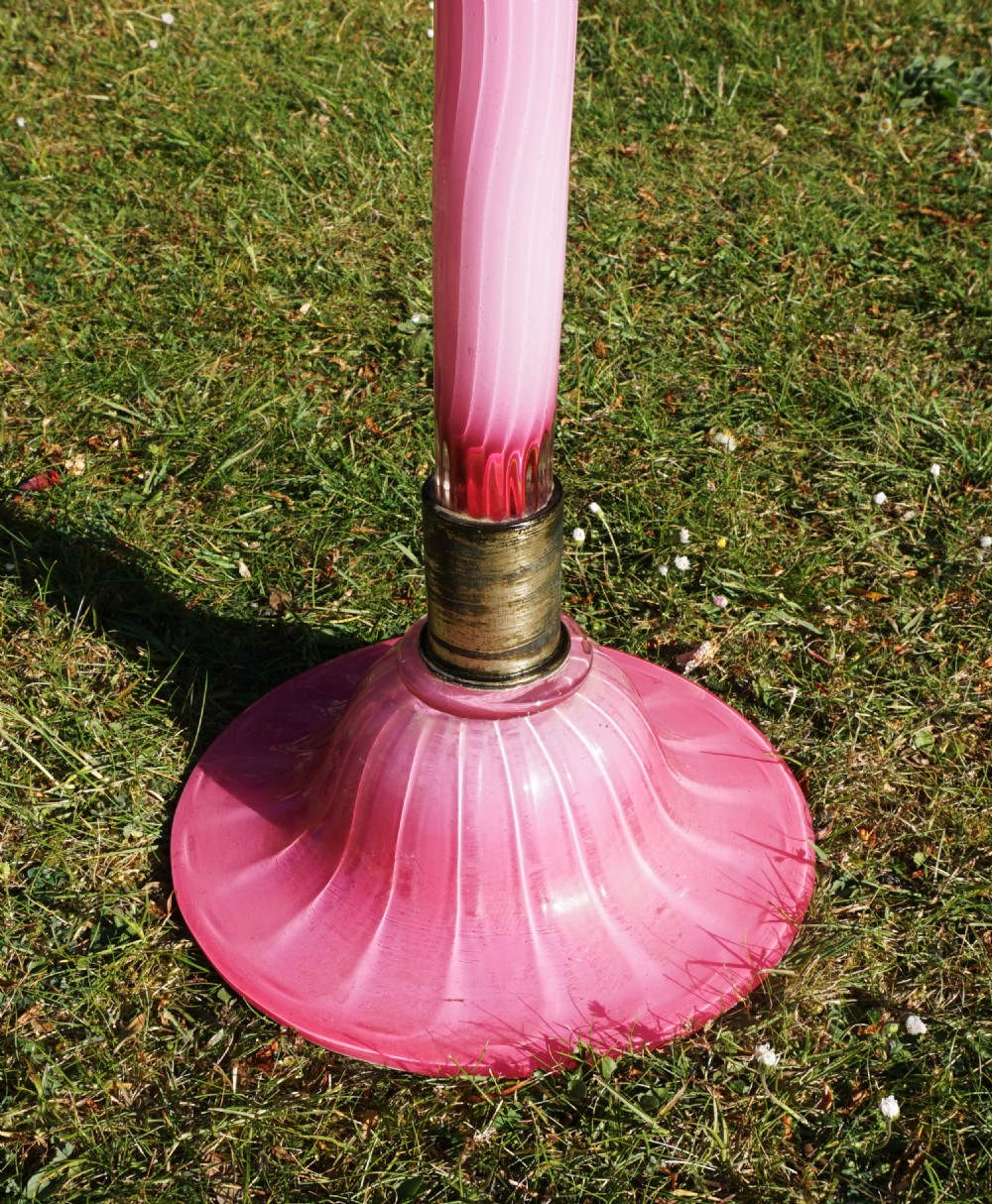 A tall slender Victorian glass lily vase featuring pink and white striped cased glass, a ruffled rim, and a domed base. View III