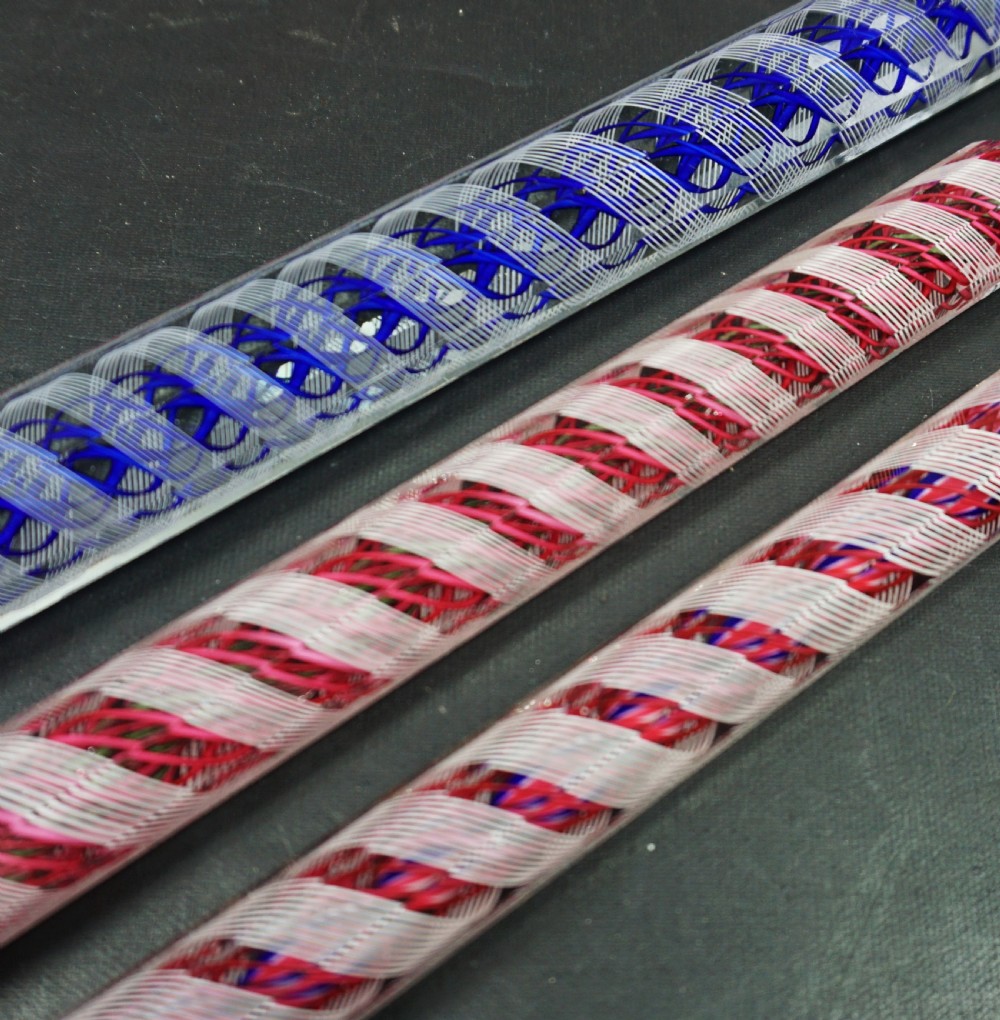 Three facet-cut clear crystal glass rulers featuring internal spiralled red, blue, and white filigree twists. View II