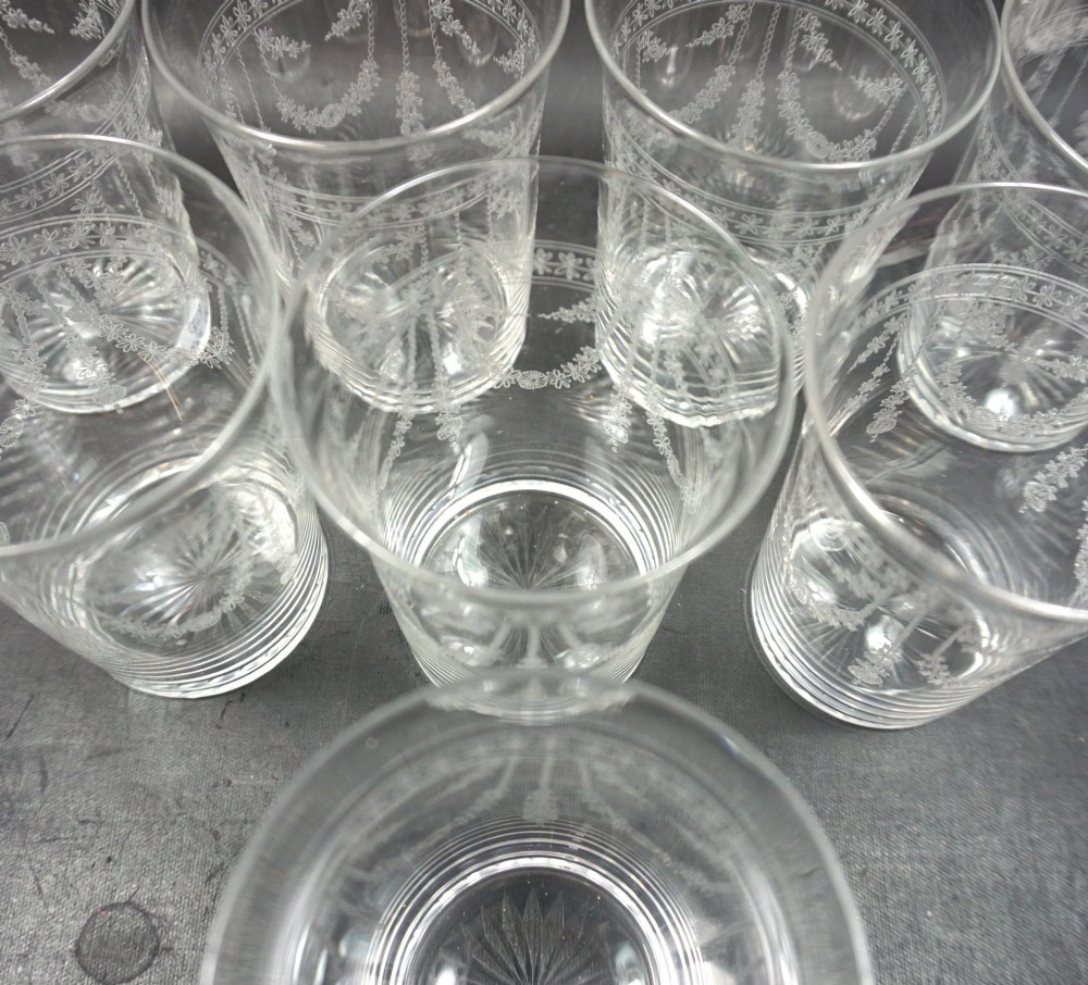 A set of eight clear crystal glass tumblers decorated with acid-etched floral festoons and starburst cut bases. View II