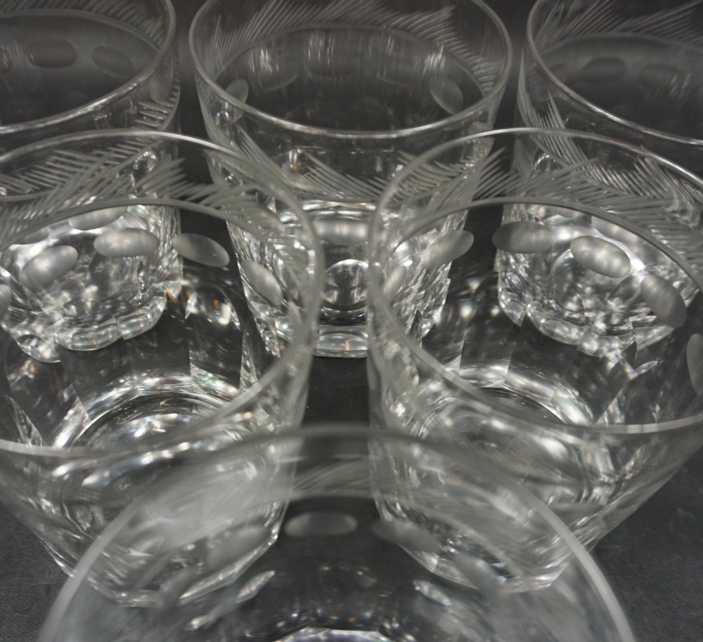 A set of six clear cut crystal glass tumblers featuring hatched rim bands, thumbprint motifs, and faceted bases. View II