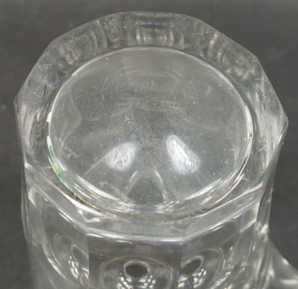 A clear heavy cut crystal glass feeding cup featuring an integrated spout and vertical flute cut detailing around the lower portion. View III