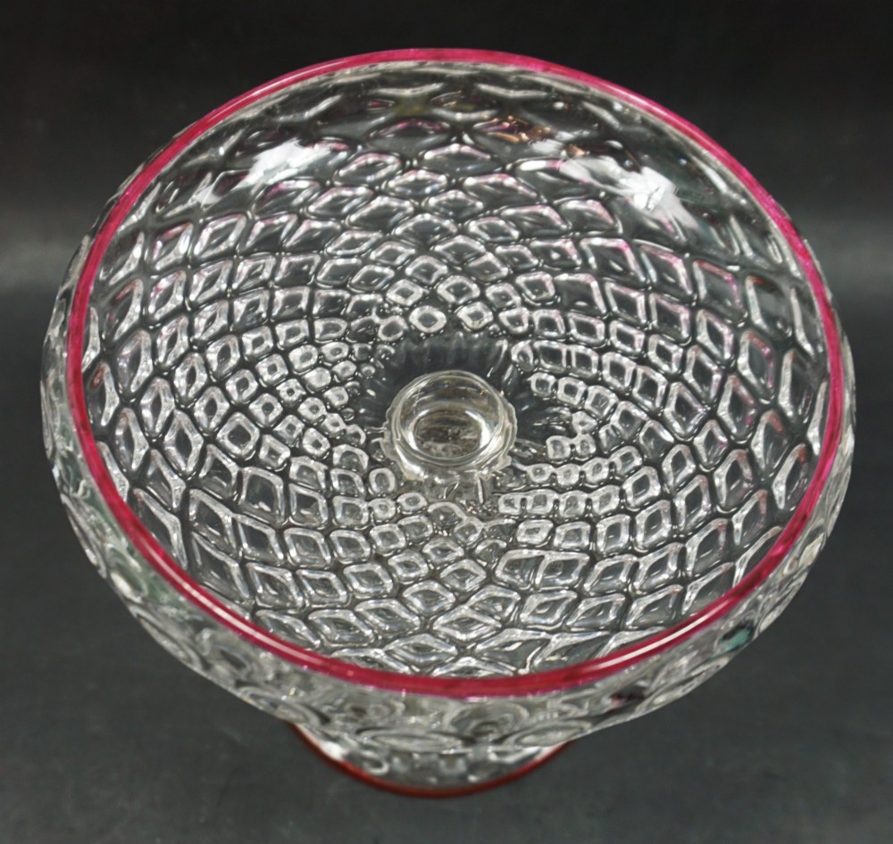 A honeycomb moulded crystal glass tazza with red cane decoration, English c.1880 View II