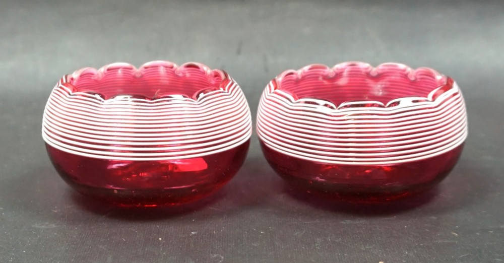 A pair for cranberry glass salt cellars with whit trail decoration, English c.1890