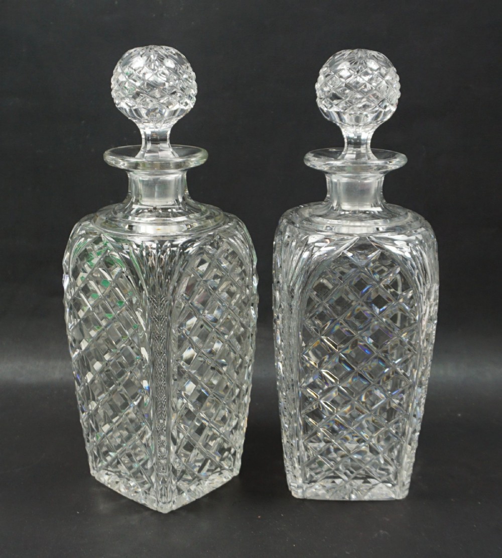 A pair of crystal glass square section tapered decanters, English c.1910