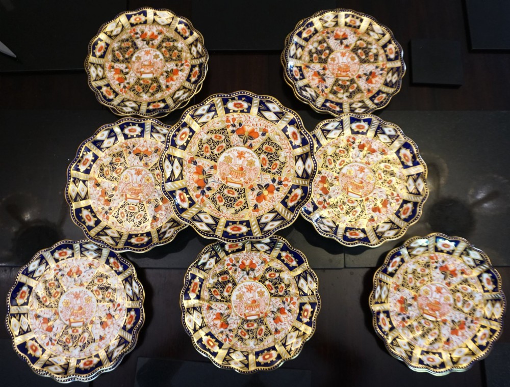 A Victorian Davenport porcelain dessert service featuring scalloped plates and footed comports decorated in a cobalt blue, iron red, and gilt Imari pattern. View II