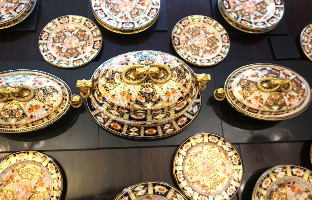 An extensive Victorian Davenport Imari pattern porcelain dinner service comprising numerous plates, serving platters, and covered tureens decorated in cobalt blue, orange, and gilt. View IV