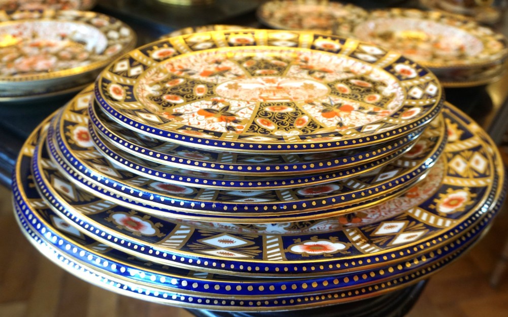 An extensive Victorian Davenport Imari pattern porcelain dinner service comprising numerous plates, serving platters, and covered tureens decorated in cobalt blue, orange, and gilt. View VII