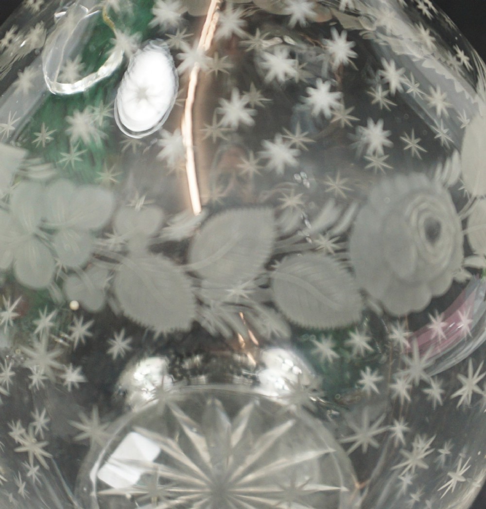 A clear Victorian crystal glass wine jug featuring engraved stars, Union floral motifs, and an applied twisted handle. View II