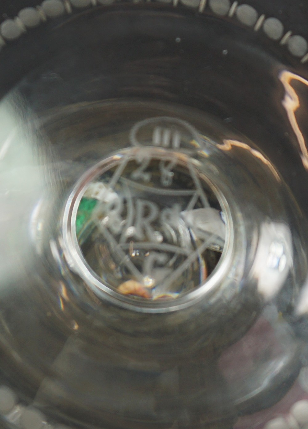 A late nineteenth-century clear lead crystal wine jug featuring wheel-engraved bird and leaf motifs, a flared rim, and a circular pedestal base. View IV