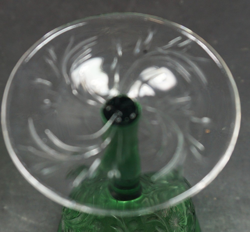 A set of eight green glass wine goblets featuring detailed intaglio engraved floral motifs and clear stemware bases. View V