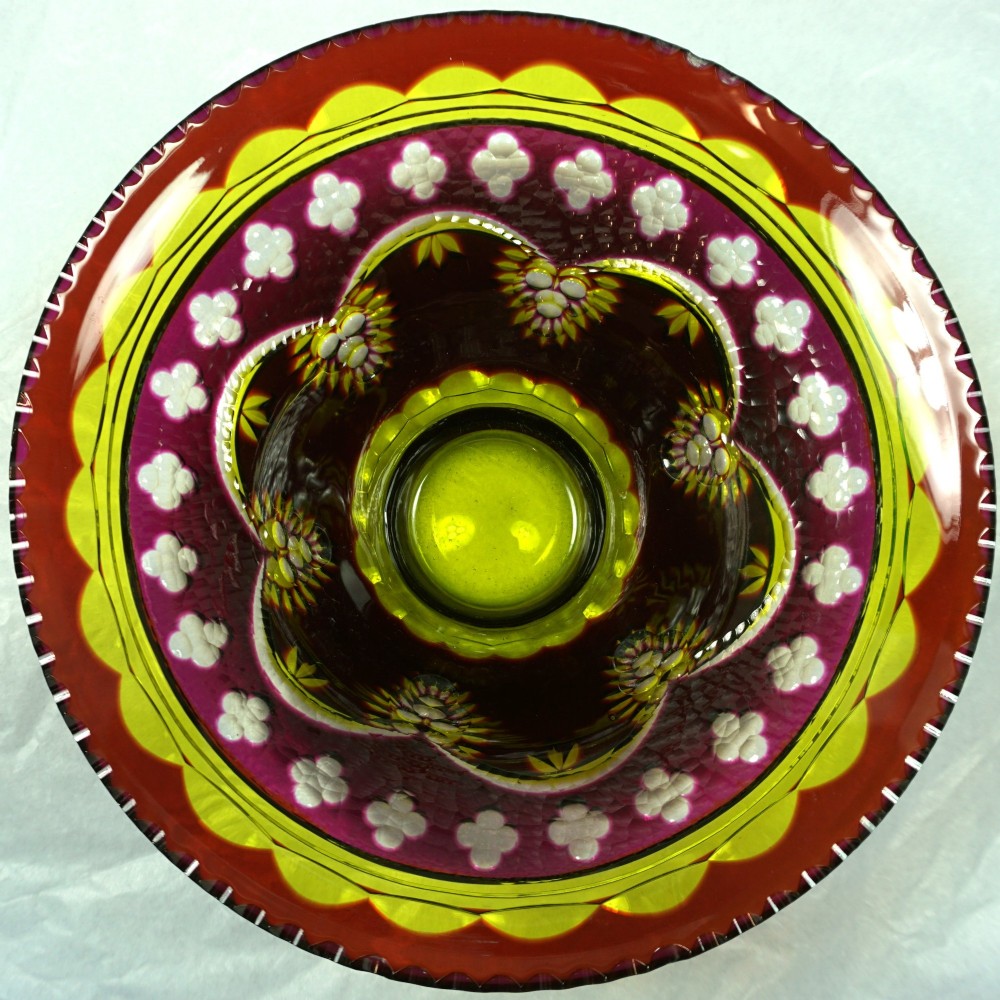 An Art Deco Val Saint Lambert multi-coloured cased glass bowl with intricate geometric cut crystal detailing viewed from above.