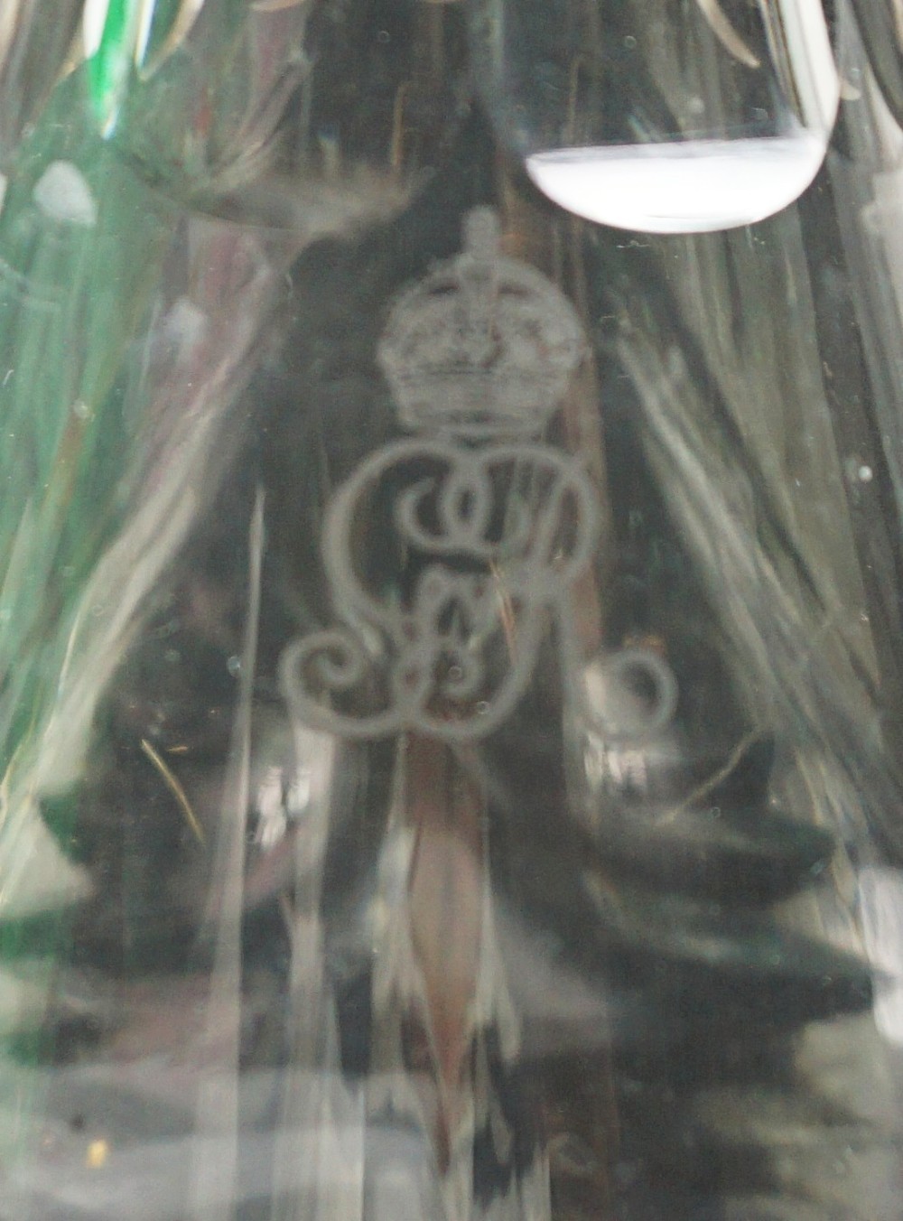 A clear glass carafe featuring a flared base with starburst cutting, fluted neck panels, and an etched Royal Cypher monogram beneath a crown. View II